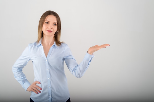 Portrait of young attractive business lady showing on white isolated background