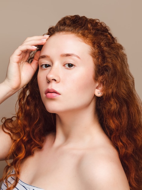 Portrait of a young attractive Scandinavian girl with red hair and freckles. Natural beauty.