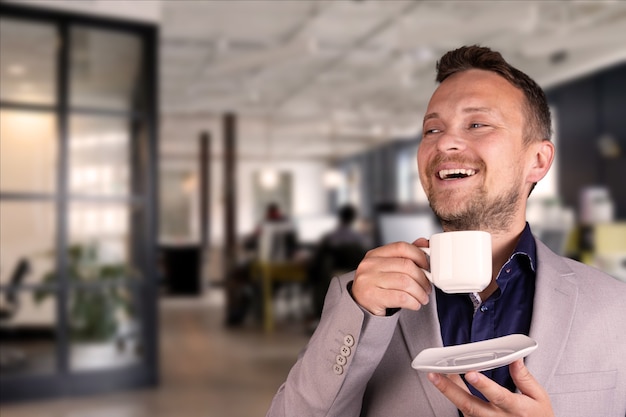 Portrait of young attractive, smiling businessman working in office. High quality photo