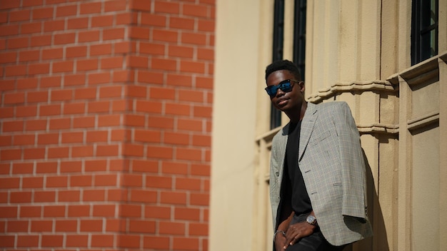 Portrait of young attractive stylish african american man model posing in casual clothes against neutral background looking sexy with afro hair. In People Youth Beauty and fashion concept.