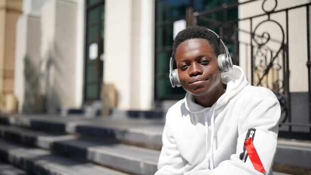 Portrait of young attractive stylish african american man model posing in casual clothes against neutral background looking sexy with afro hair. In People Youth Beauty and fashion concept.