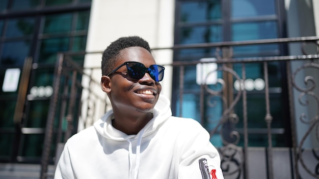 Portrait of young attractive stylish african american man model posing in casual clothes against neutral background looking sexy with afro hair. In People Youth Beauty and fashion concept.