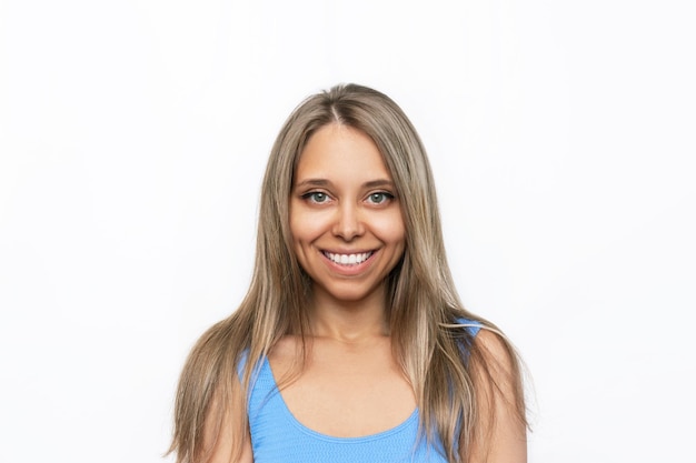 Portrait of a young attractive tanned happy caucasian smiling blonde woman on a white background