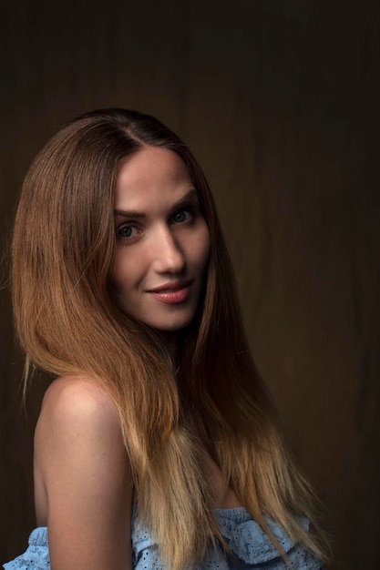 portrait of a young attractive woman on a dark background