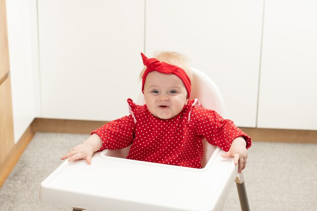 Portrait of Young Baby Girl in High Chair