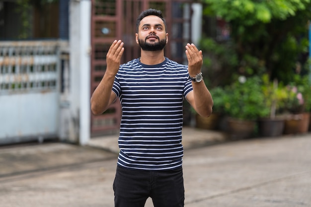 Portrait of young bearded Indian man in the streets outdoors