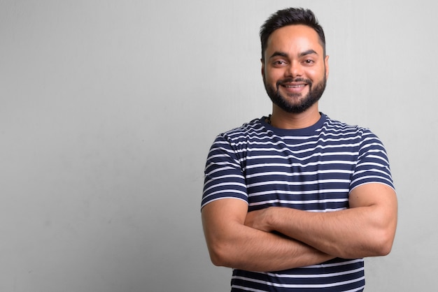 portrait of young bearded Indian man on white