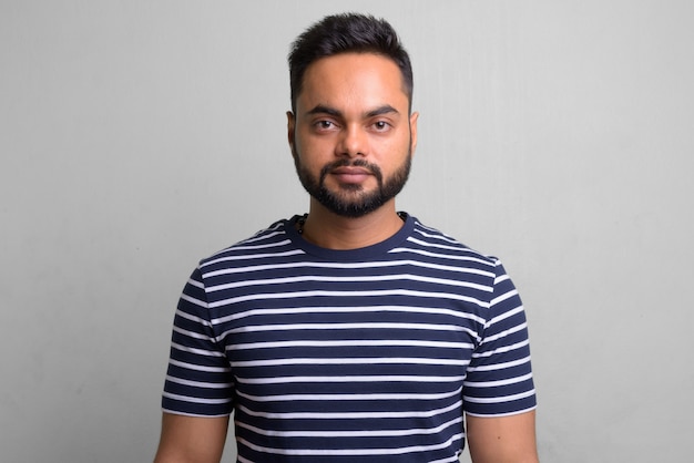 portrait of young bearded Indian man on white