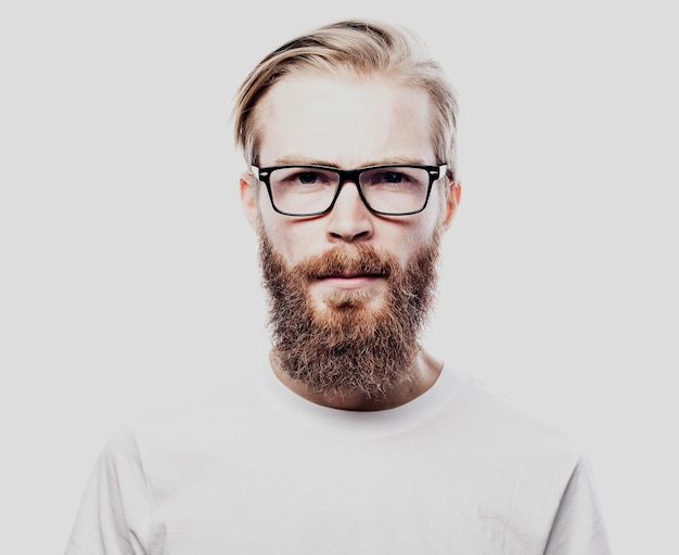 Portrait of a young bearded man frowning Studio shot