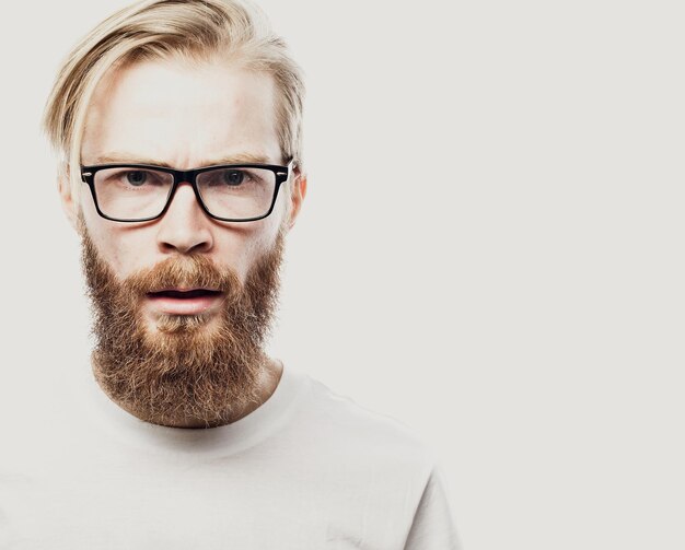 Portrait of a young bearded man frowning Studio shot