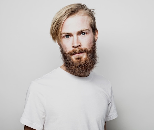 Portrait of a young bearded man in a white Tshirt