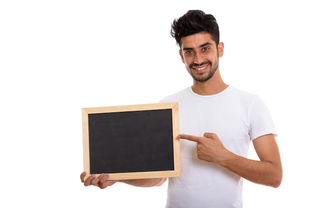 Portrait of young bearded Persian man holding blackboard