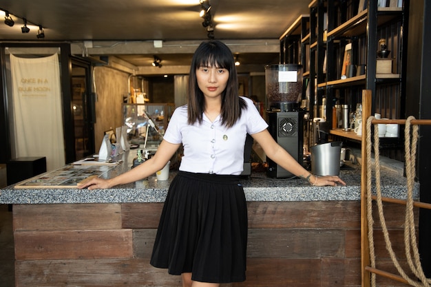 portrait of young beautiful asian school girl at coffee shop