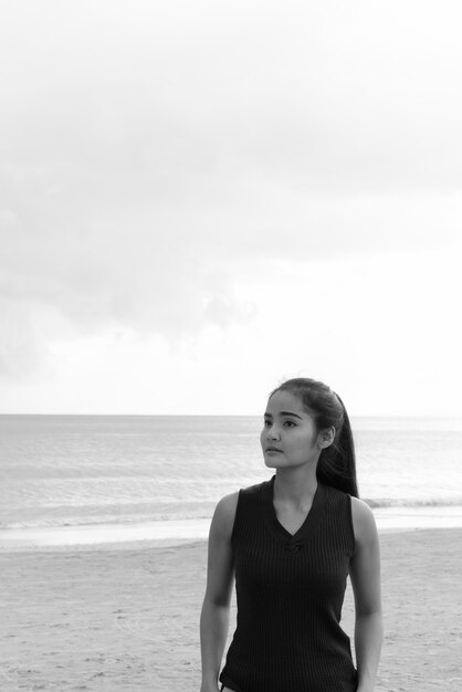 Portrait of young beautiful Asian tourist woman enjoying vacation at Koh Lanta island in Thailand