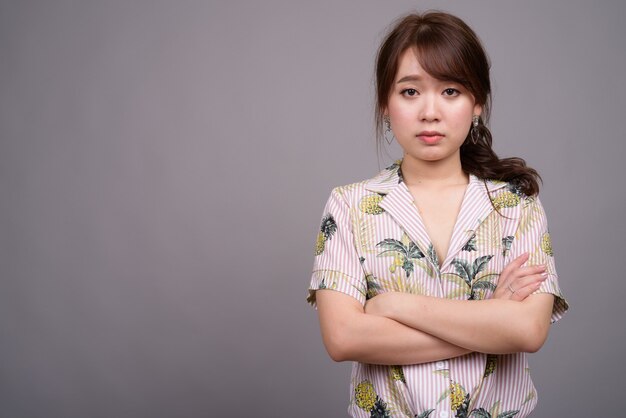 Portrait of young beautiful Asian tourist woman 