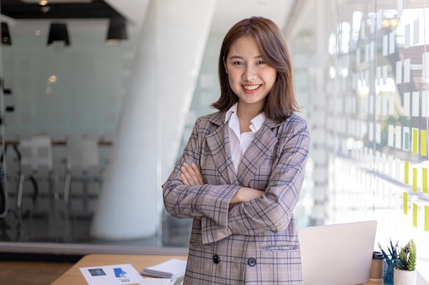 Portrait of a young beautiful Asian woman in a office room, concept image of Asian business woman, modern female executive, startup business woman, business leader woman.