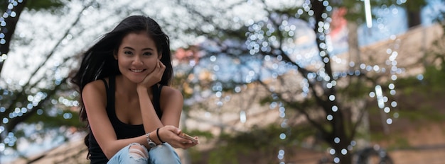 Portrait of young beautiful Asian woman in the streets outdoors