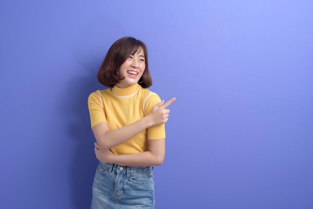 A portrait of young beautiful asian woman over studio background