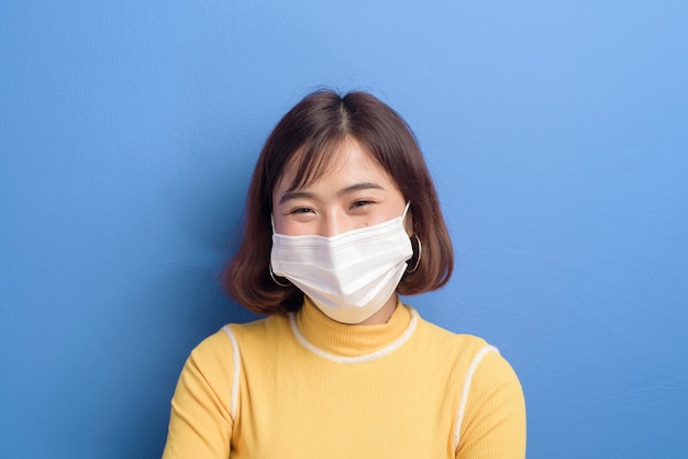 A portrait of young beautiful asian woman wearing a surgical mask