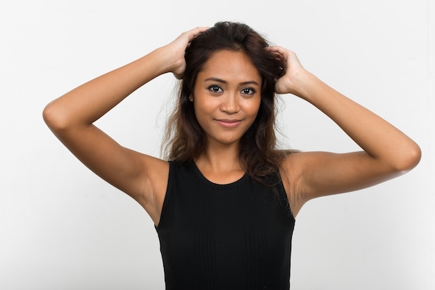 Portrait of young beautiful Asian woman with brown hair