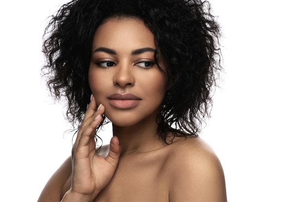 Portrait of young beautiful black woman with smooth skin on white background