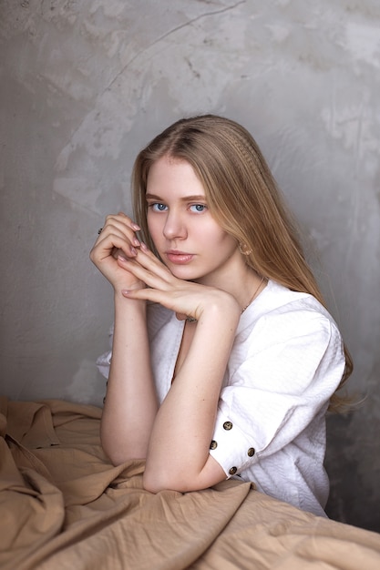 Portrait of young beautiful blond girl smiling