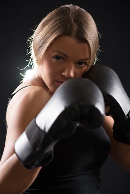 Portrait of Young beautiful boxing girl standing with a guard ready to punch.