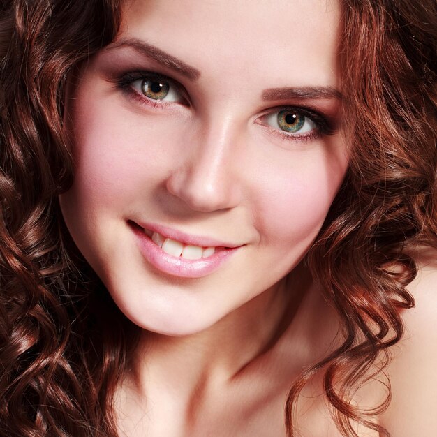 Portrait of a young beautiful brunette twenty year old woman isolated against white background