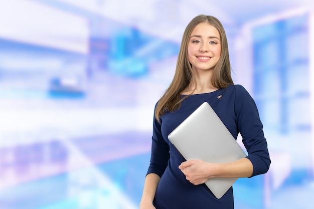 Portrait of young beautiful brunnete woman holding laptop