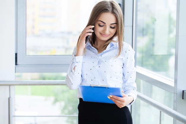 Portrait of young beautiful business woman in the office