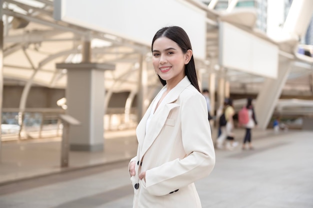 Portrait of young beautiful businesswoman in modern city