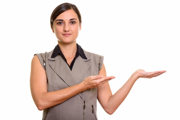 Portrait of young beautiful businesswoman showing something