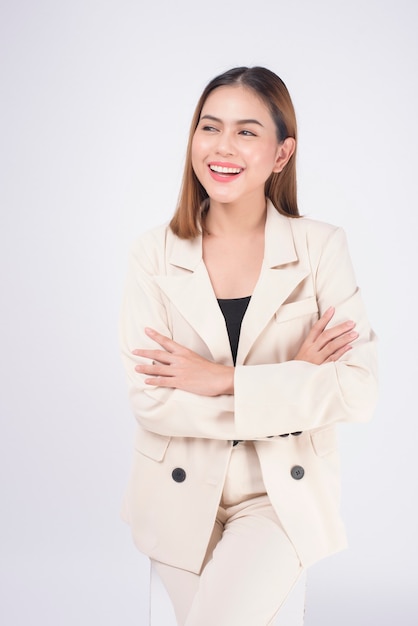 Portrait of young beautiful businesswoman wearing suit in white background studio.