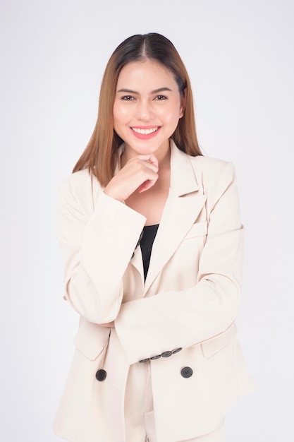 Portrait of young beautiful businesswoman wearing suit in white background studio.