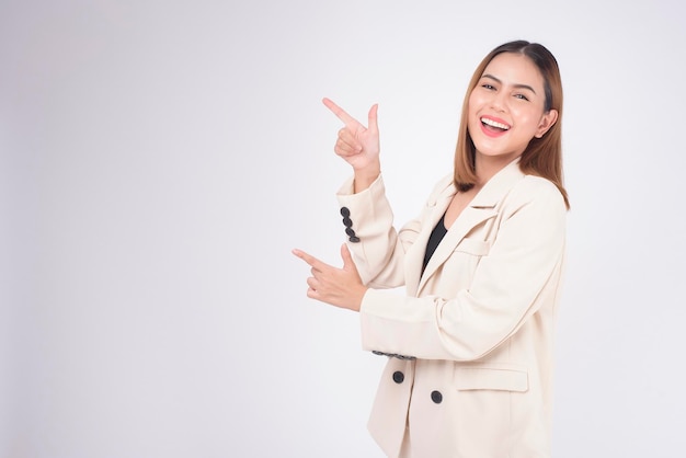 Portrait of young beautiful businesswoman wearing suit in white background studio.