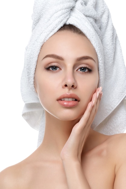 Portrait of young beautiful caucasian woman touching her face isolated. Cleaning face, perfect skin.