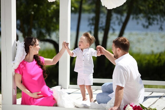 Portrait of a young beautiful family with pregnant mother