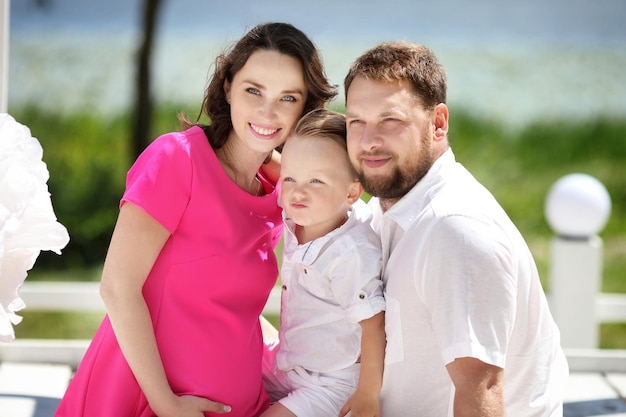 Portrait of a young beautiful family with pregnant mother