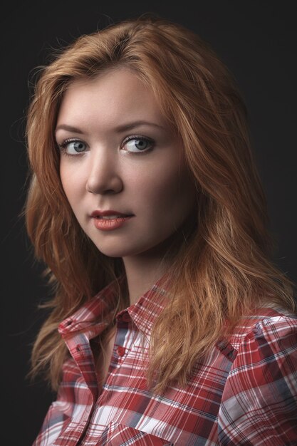 Portrait of the young beautiful girl on a black background