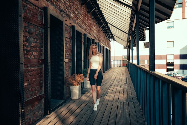 Portrait of a young beautiful girl on a city street in summer