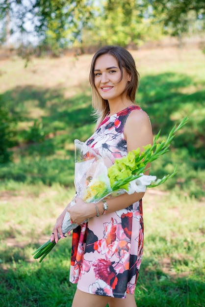 Portrait of a young beautiful girl in dress outdoors