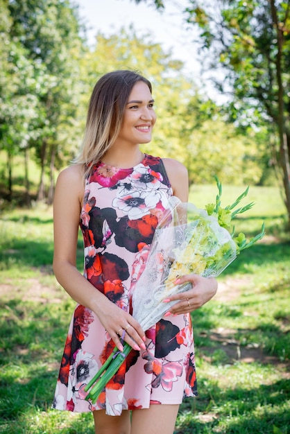 Portrait of a young beautiful girl in dress outdoors