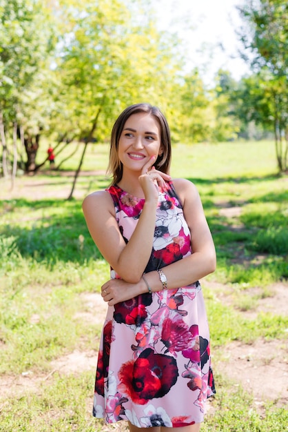 Portrait of a young beautiful girl in dress outdoors