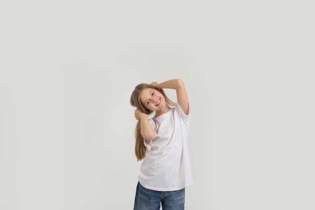 Portrait of a young beautiful girl holding her hair with cookies on a white background.