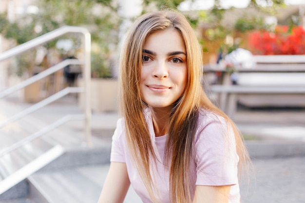 Portrait of young beautiful girl posing on street