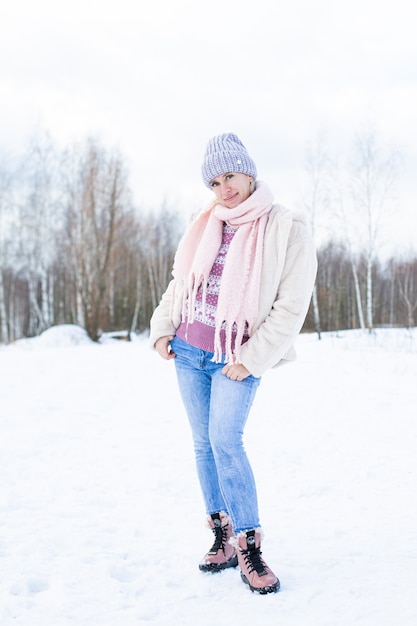 Portrait of a young beautiful girl in the street in winter