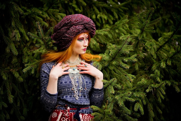 Portrait of a young beautiful girl in a turban in the autumn garden