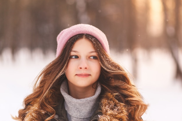 Portrait of a young beautiful girl in winter in nature close-up