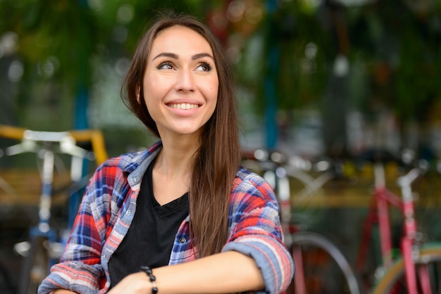 Portrait of young beautiful hipster woman in the city streets outdoors