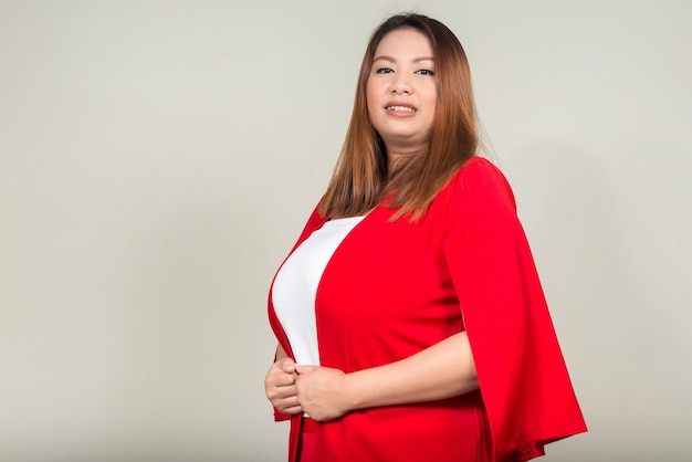 Portrait of young beautiful overweight Asian businesswoman